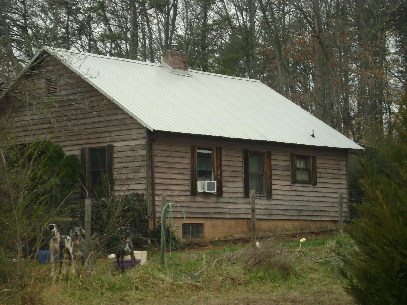 White metal roof on an old wood sided farmhouse, from a Metal Roof Installation job in Allensville